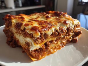 Close-up of a thick slice of Lasagna with Cottage Cheese showing layers of meat sauce and creamy white filling.