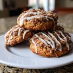 A stack of three delicious coffee cake cookies topped with cinnamon streusel and drizzled with white icing.