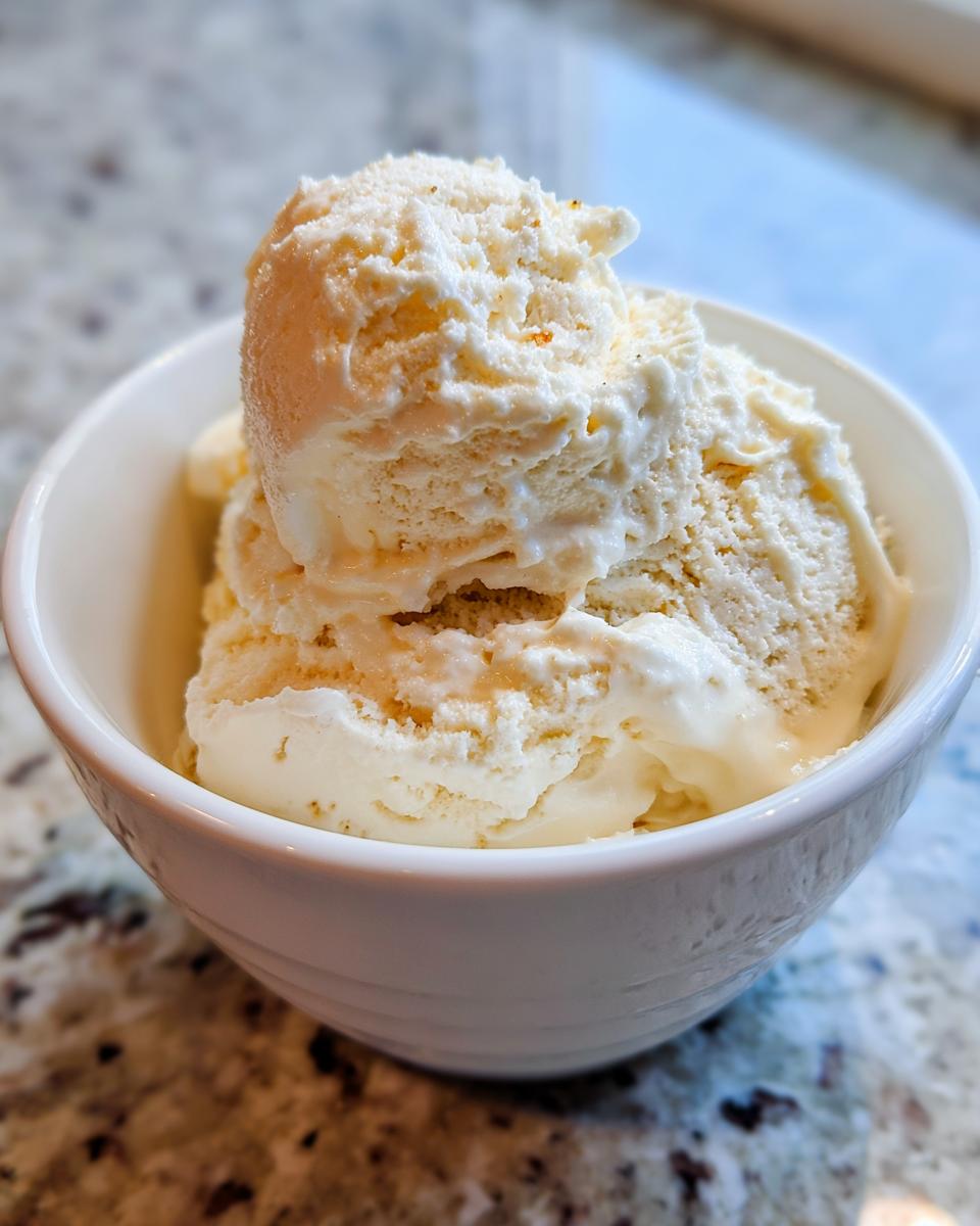 Close-up of creamy scoops of homemade banana ice cream served in a white bowl.