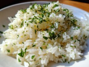 Close-up of fluffy white rice seasoned with butter and topped generously with fresh chopped parsley, perfect garlic butter rice.