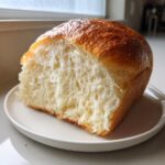 Close-up of a slice showing the incredibly soft, fluffy crumb texture of homemade japanese milk bread.
