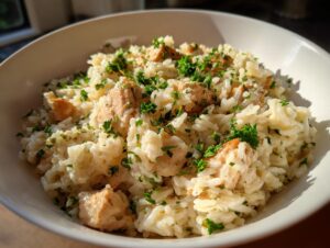 Close-up of creamy one pot chicken and rice topped generously with fresh chopped parsley.