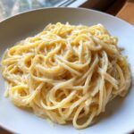 Close-up of creamy, cheesy spaghetti coated in sauce, representing the 25-minute parmesan pasta recipe.