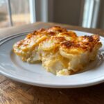 Two servings of creamy, cheesy pioneer woman scalloped potatoes recipe with a golden-brown baked top.